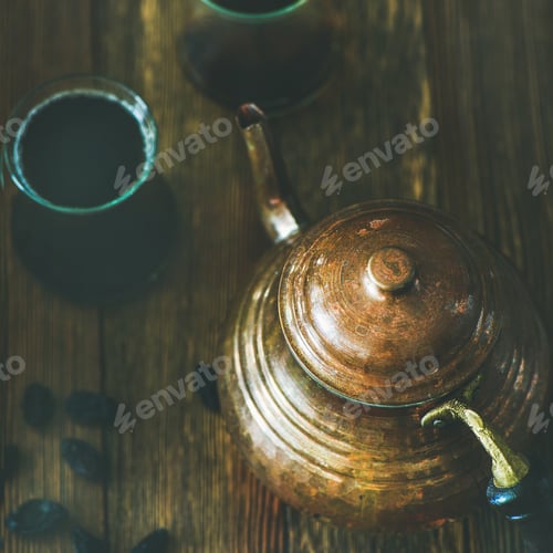 Preview: Oriental teapot, black tea in glasses and raisins, square crop