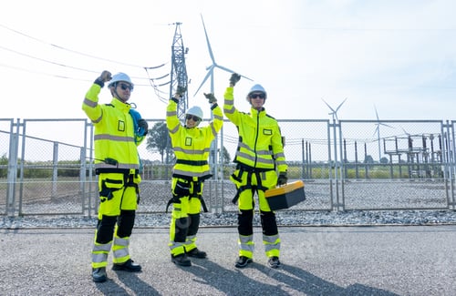 Preview: Three wind turbine or windmill workers or engineers stand with raise hands up to express happiness