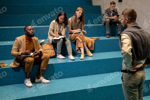 Preview: Young intercultural students listening to their coach or teacher