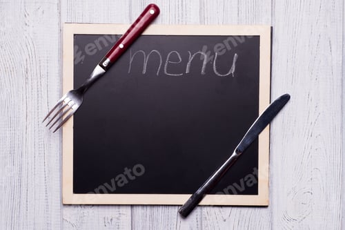 Black Menu Board with Fork and Knife Utensils
