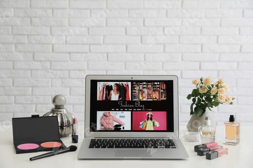 Preview: Laptop with open fashion blogger site on table