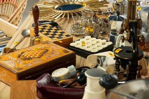 Preview: Many different items on wooden table. Garage sale