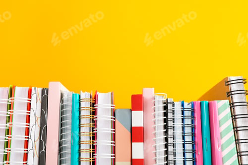 Preview: Stack of colorful books against background, space for text
