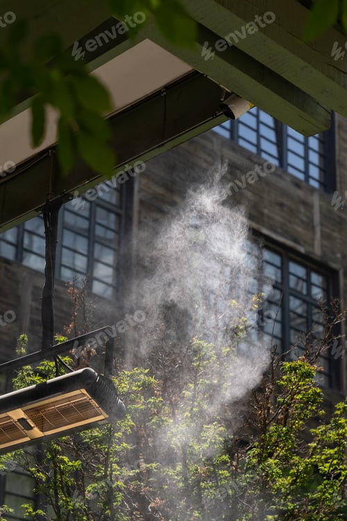 Preview: Facility that lowers temperature by spraying water. Water fog machine working during hot summer day