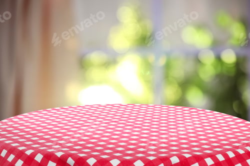 Preview: Red and white checkered tablecloth on table near window. Space for design
