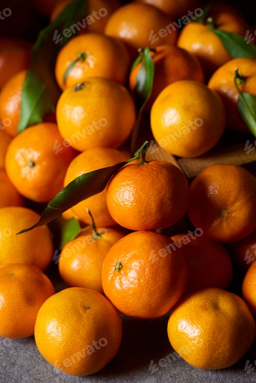 Preview: selective focus of orange tangerines with green leaves