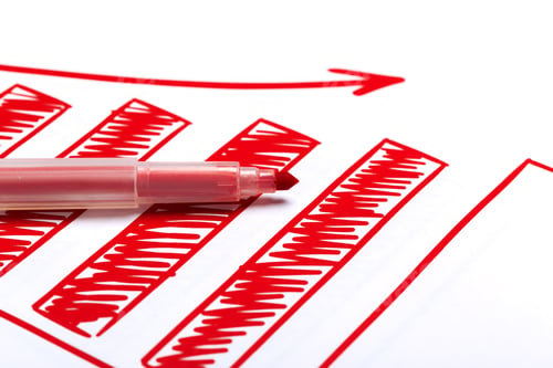 Preview: Red marker creates upward trend on paper during business planning session