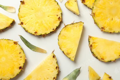 Preview: Ripe pineapple slices on white background, top view