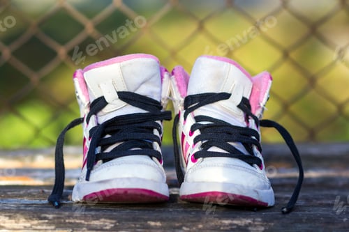 Preview: Pair of child white shoes on nature background