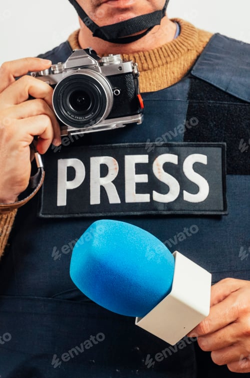 Preview: Reporter in bulletproof vest with a camera.