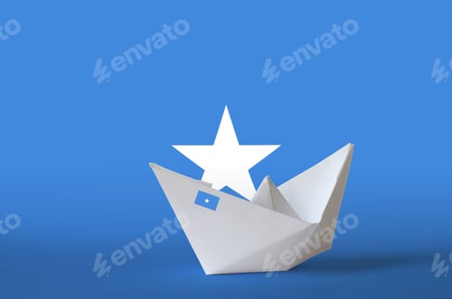 Preview: Somalia flag depicted on paper origami ship closeup. Oriental handmade arts concept