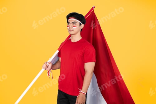 Preview: Indonesian man holding red and white flag as his country's flag