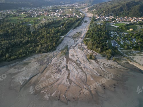 Preview: Aerial view of a dried riverbed and surrounding village.