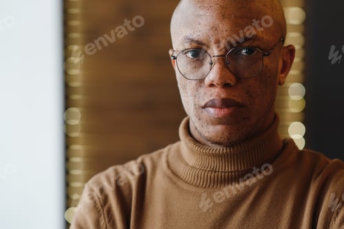 Preview: Man Wearing Glasses and a Brown Turtleneck