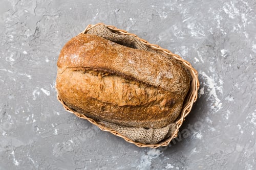 Preview: Freshly baked bread on basket against natural background. top view bread copy space
