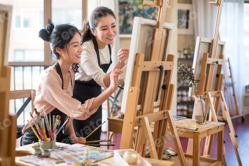 Preview: Young women painting in studio