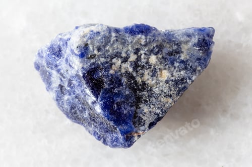 Preview: sample of raw sodalite rock on white marble