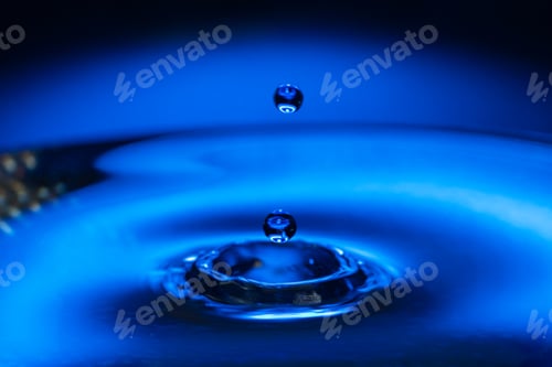Preview: Macro water drop on a blue background and circles on it. Round water drop. splashes out of water
