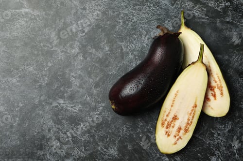 Preview: Fresh raw eggplants on black smokey background