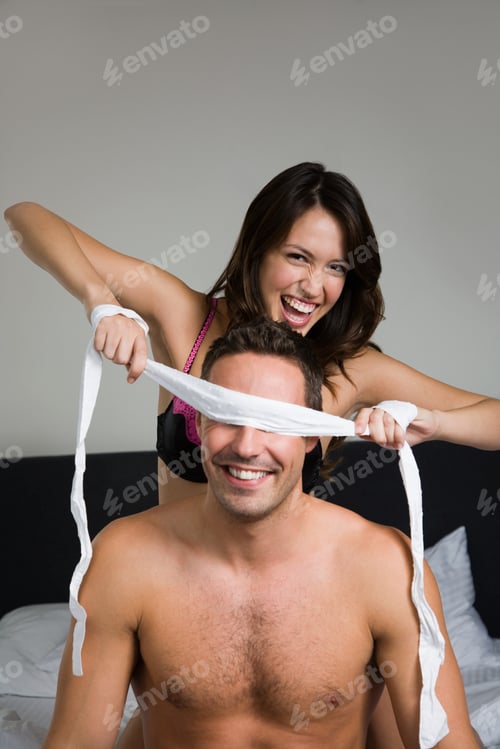 Preview: A woman blindfolding a man