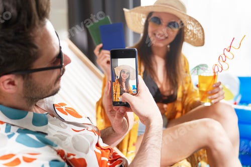 Preview: Close up of man taking a photo of a woman