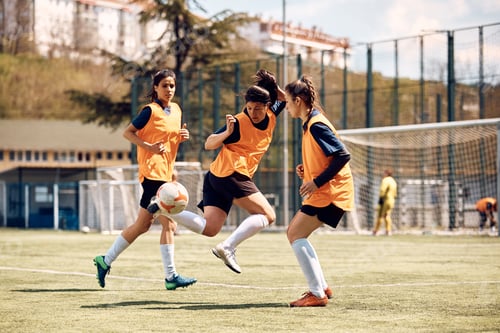 Preview: Skillful female soccer player in action during sports training at the stadium.