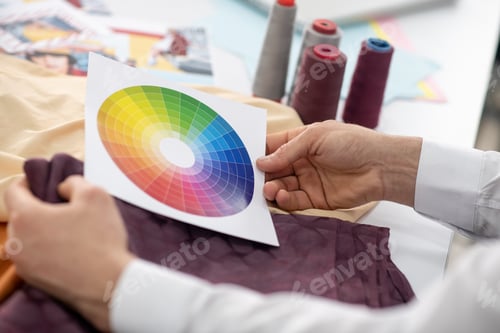 Preview: Hands of male tailor holding color palette and cloth