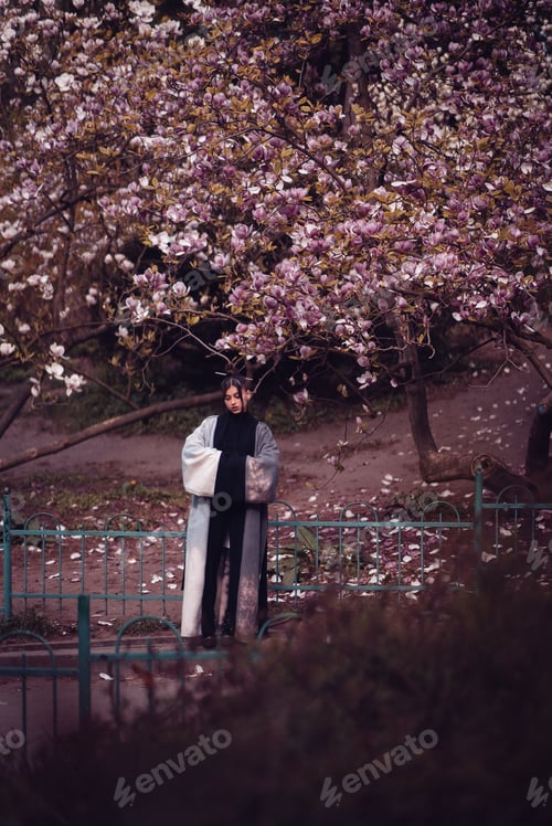 Preview: Beautiful young woman wearing kimono with cherry blossoms, sakura view