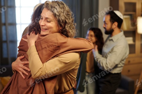 Preview: Two happy women in quiet luxury attire embracing each other