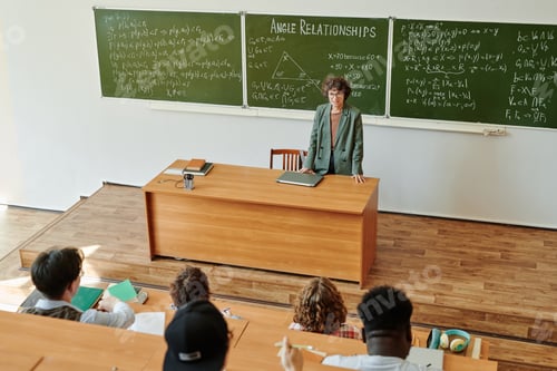 Preview: Young confident teacher of algebra explaining angle relationships to students