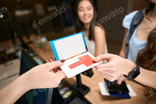 Preview: Handing over key to hotel room at reception to visitors