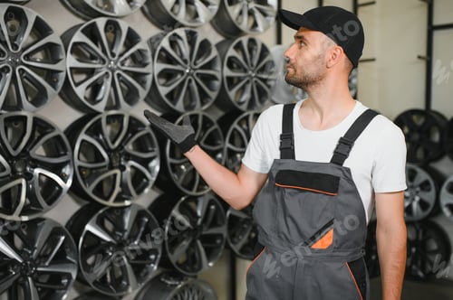 Preview: Male seller in car tire store