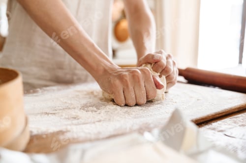 Preview: Close up of a young girl baking at the kitchen
