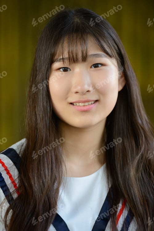 Preview: Happy young beautiful Asian teenage girl against bamboo fence