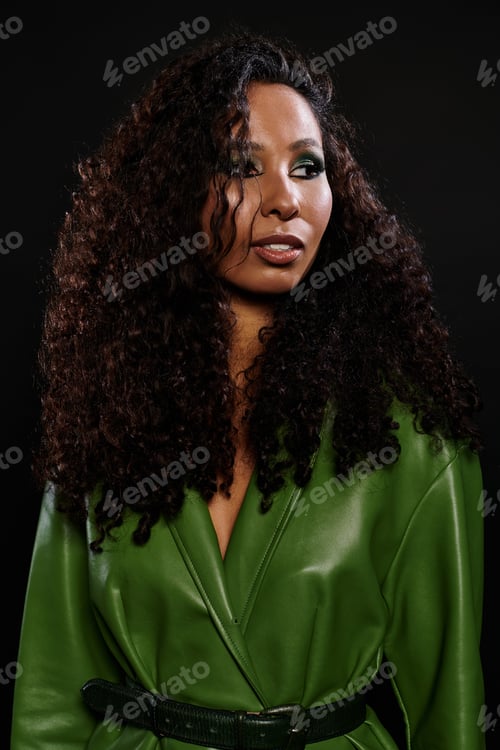 Preview: Captivating beauty exuding elegance in a striking green ensemble against a dark background