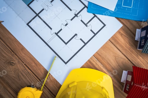 Preview: Top view desk of Engineer tools meticulously designs structures at desk, referring to blueprints