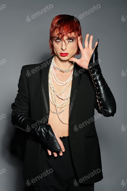 Preview: A unique young man boldly showcases a playful fashion statement against a minimal backdrop.