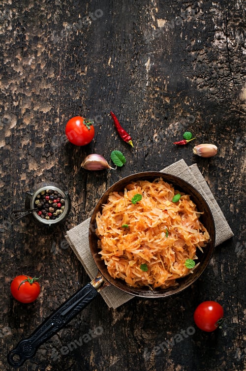 Preview: Stewed cabbage on the old wooden background in rustic style. Top view