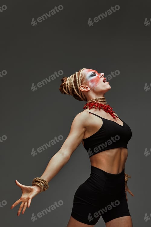 Preview: close up portrait of young beautiful girl with colorful face painting. Halloween professional makeup