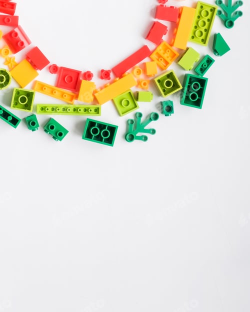 Preview: Colorful plastic building blocks flat lay on white background. Child developing game. Developing