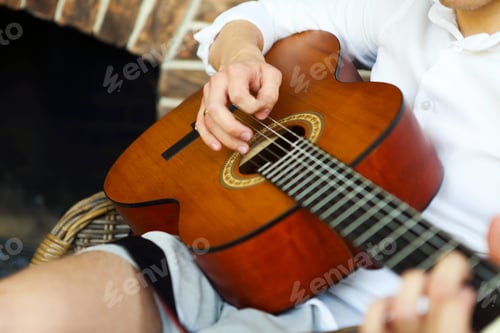 Preview: Crop man playing acoustic guitar