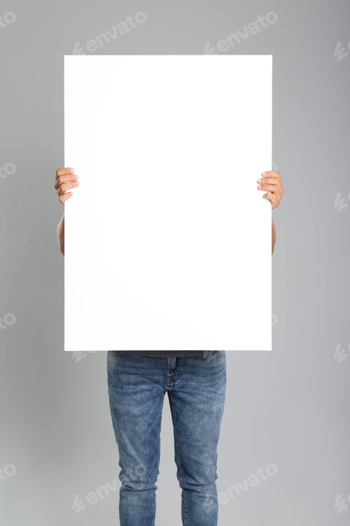 Preview: Man holding white blank poster on grey background. Mockup for design
