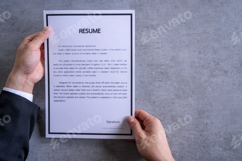 Preview: Businessman Analyzing Resume Filling resume on wooden table, Businessman Reading holding resume appl