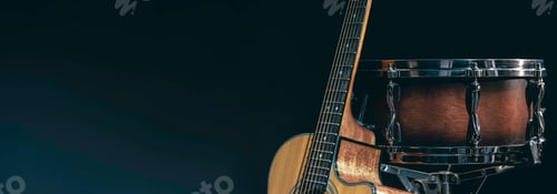Preview: Acoustic guitar and snare drum on a black background isolated.