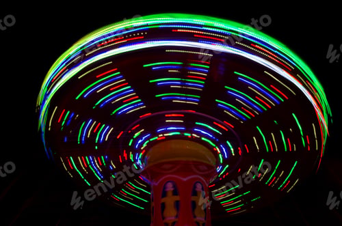 Preview: Carnival amusement park ride with swings. Spinning fair ride at night with bright color lights