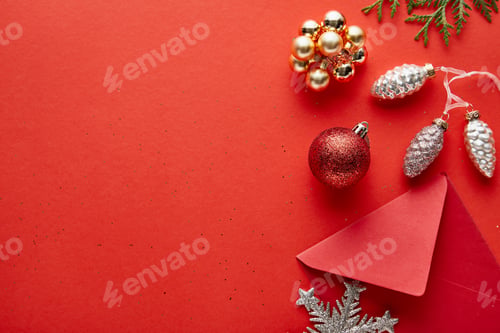 Preview: top view of shiny Christmas decoration, envelope and thuja on red background with copy space