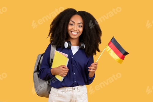 Preview: Happy black lady student with German flag and notebooks on yellow background