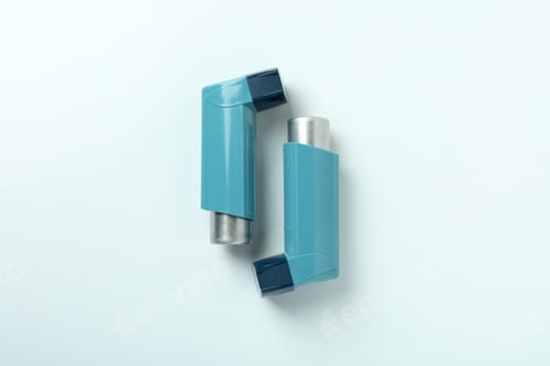 Preview: Blue asthma inhalers on white background, top view