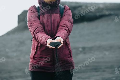 Preview: Female traveler hands playing with sand. Nomadic travel road trip and vacation concept. Close up cop