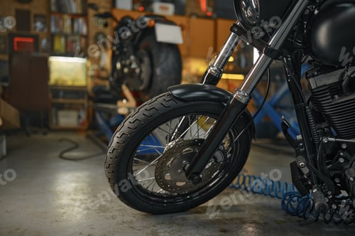 Preview: Selective focus on motorcycle wheel, maintenance and repair motorbike in garage